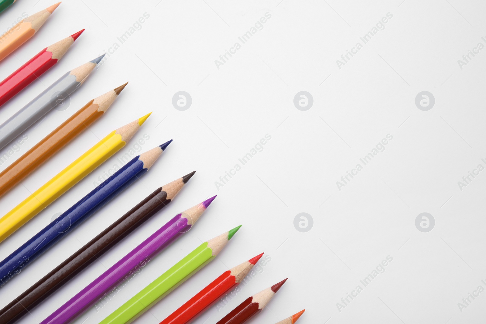 Photo of Colorful wooden pencils on white background, flat lay. Space for text