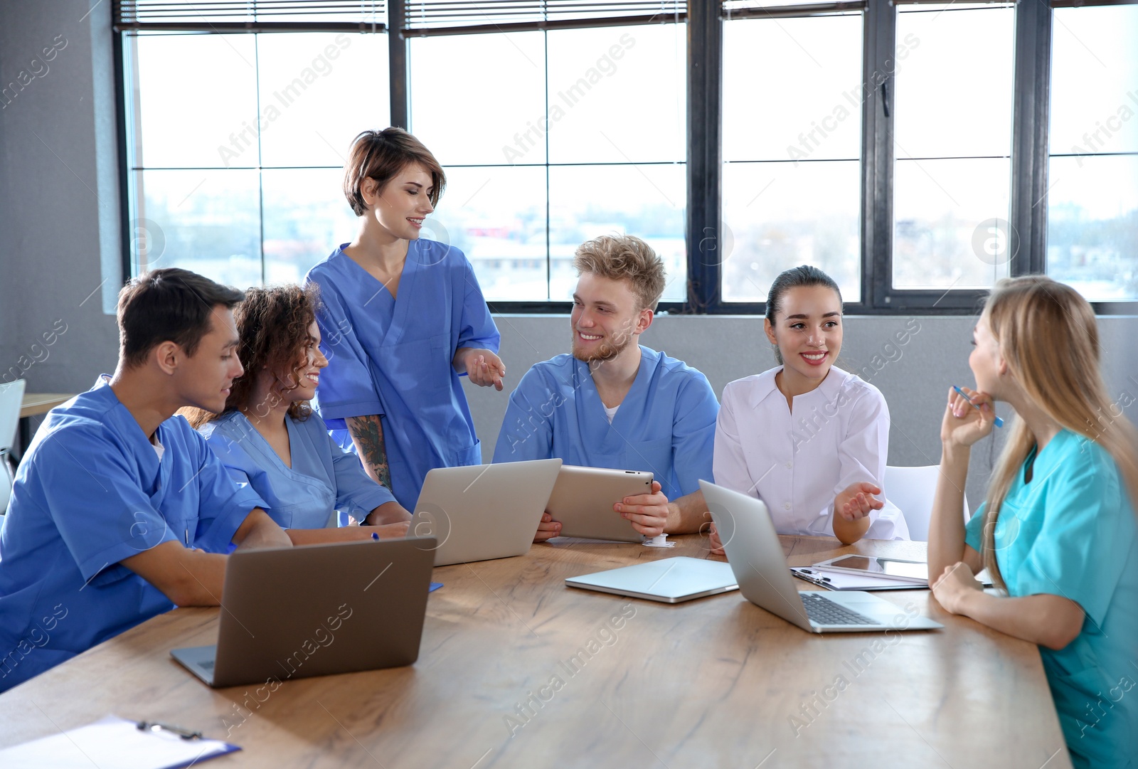 Photo of Group of smart medical students with gadgets in college