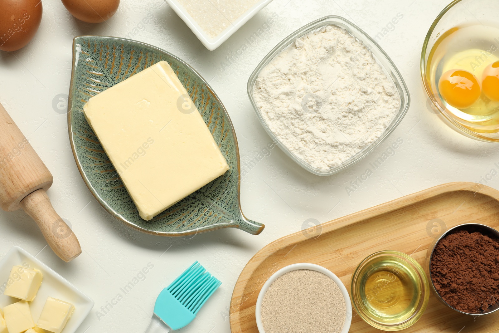 Photo of Flat lay composition with fresh butter among other products on white table