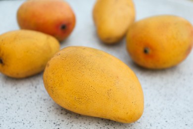 Photo of Delicious ripe juicy mangos on table, closeup