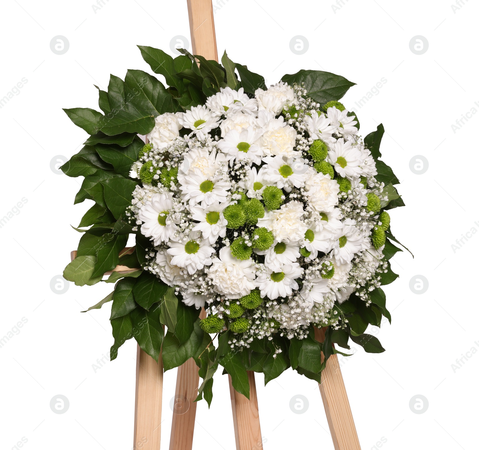 Photo of Funeral wreath of flowers on wooden stand against white background