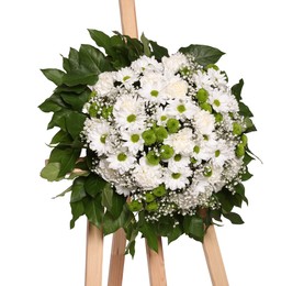 Photo of Funeral wreath of flowers on wooden stand against white background