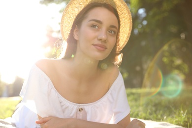 Beautiful young woman in park on sunny day