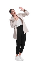 Beautiful businesswoman in suit avoiding something on white background
