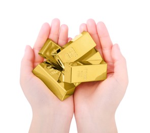 Woman holding shiny gold bars on white background, top view