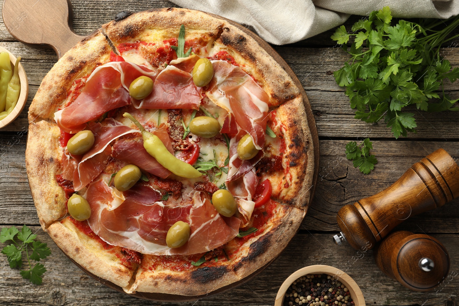 Photo of Tasty pizza and ingredients on wooden table, top view