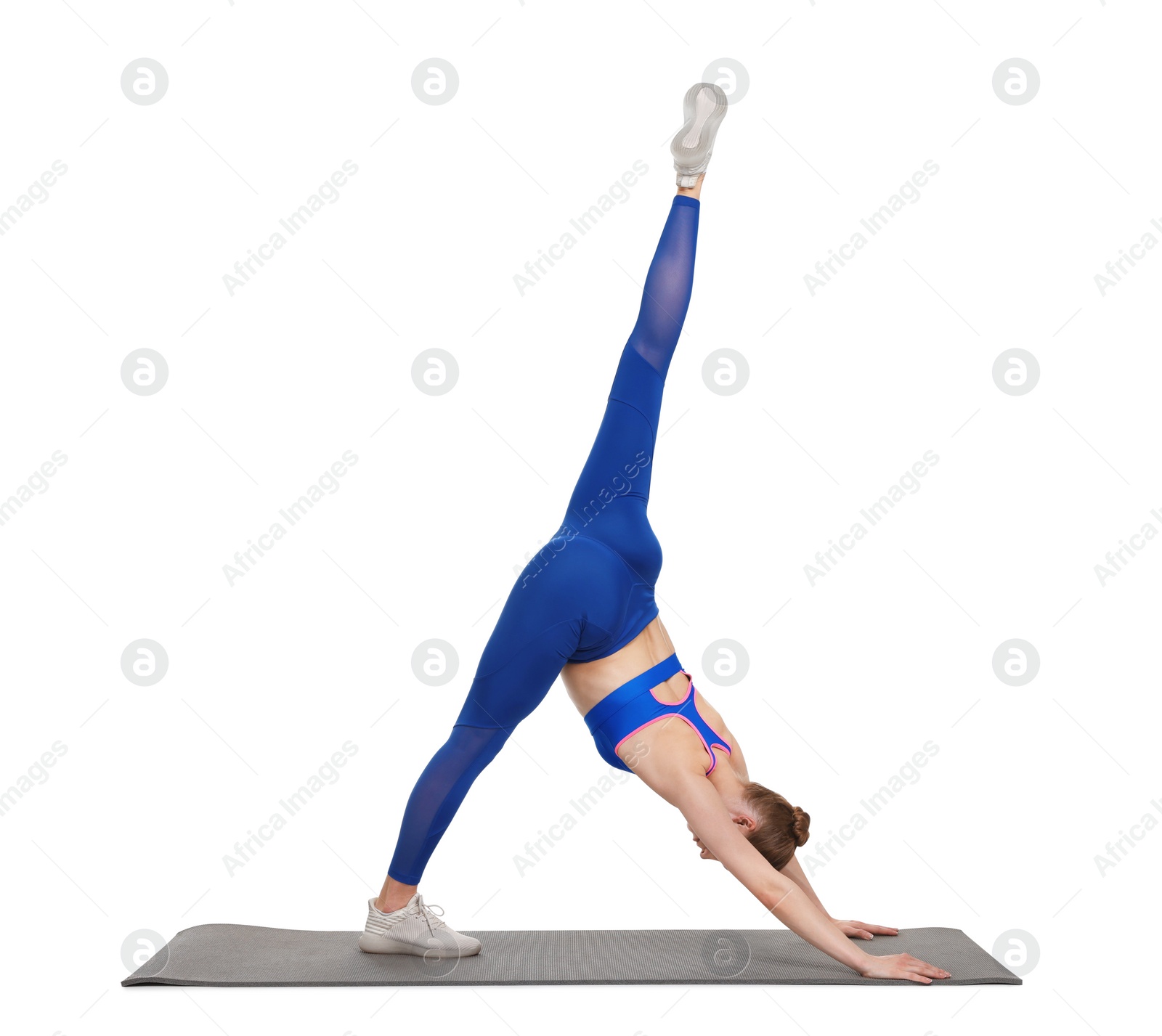 Photo of Yoga workout. Young woman stretching on white background