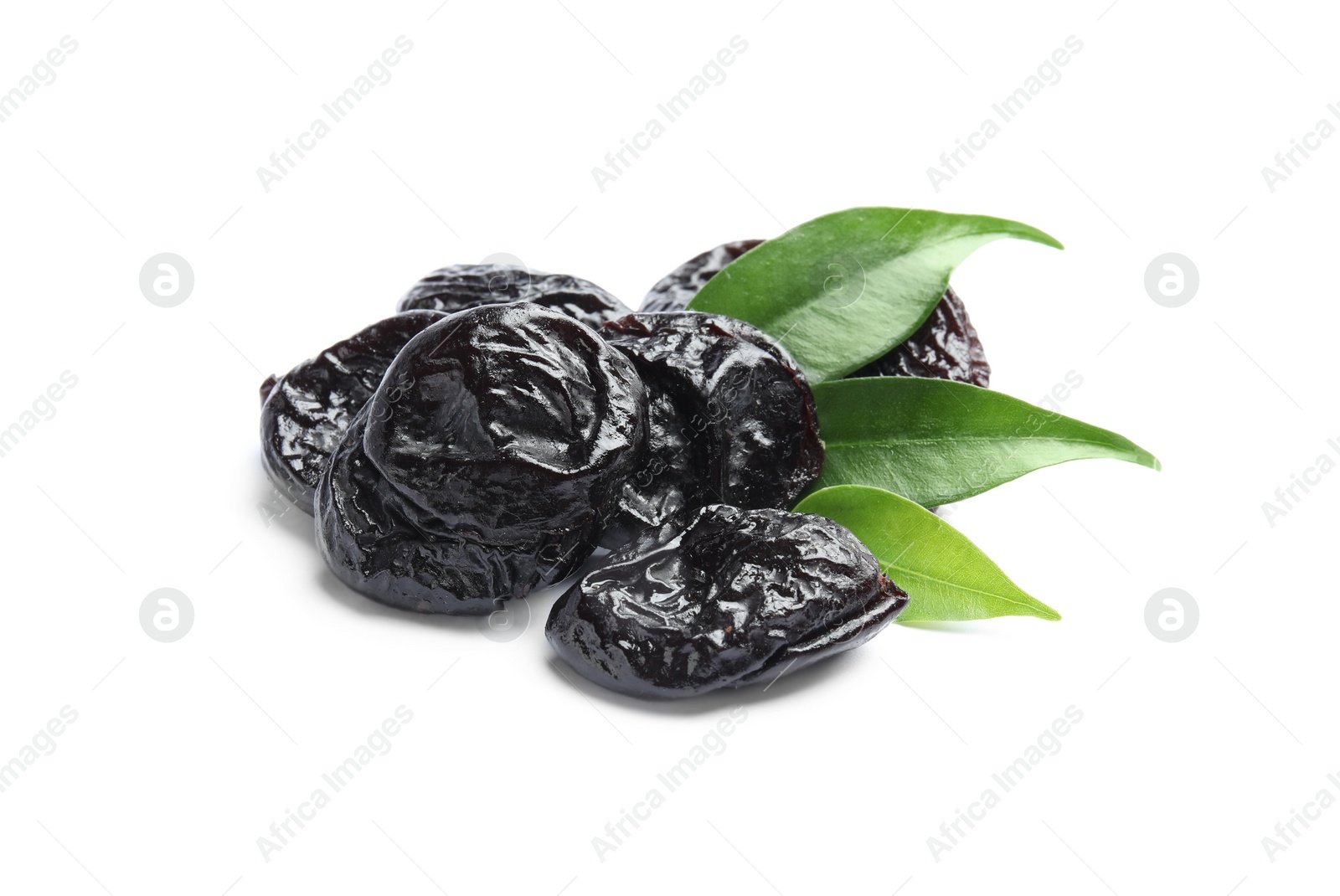 Photo of Tasty prunes and leaves on white background. Dried fruit as healthy snack