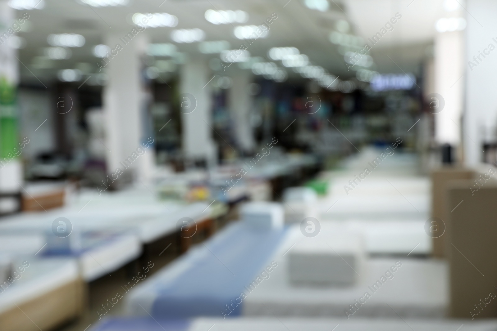 Image of Modern furniture and mattress store, blurred view