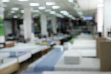 Image of Modern furniture and mattress store, blurred view