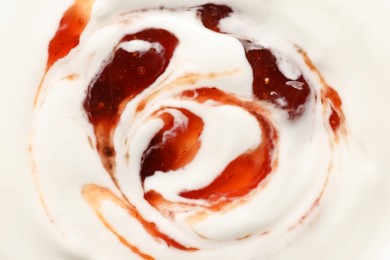 Photo of Tasty yoghurt with jam as background, top view