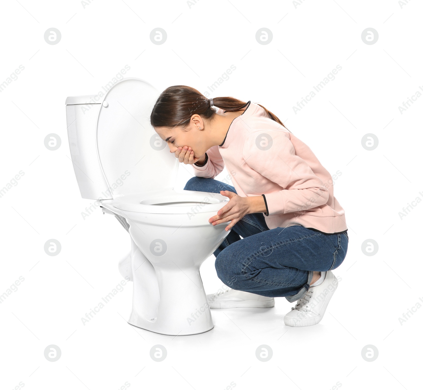 Photo of Young woman suffering from nausea near toilet bowl isolated on white