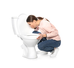 Photo of Young woman suffering from nausea near toilet bowl isolated on white