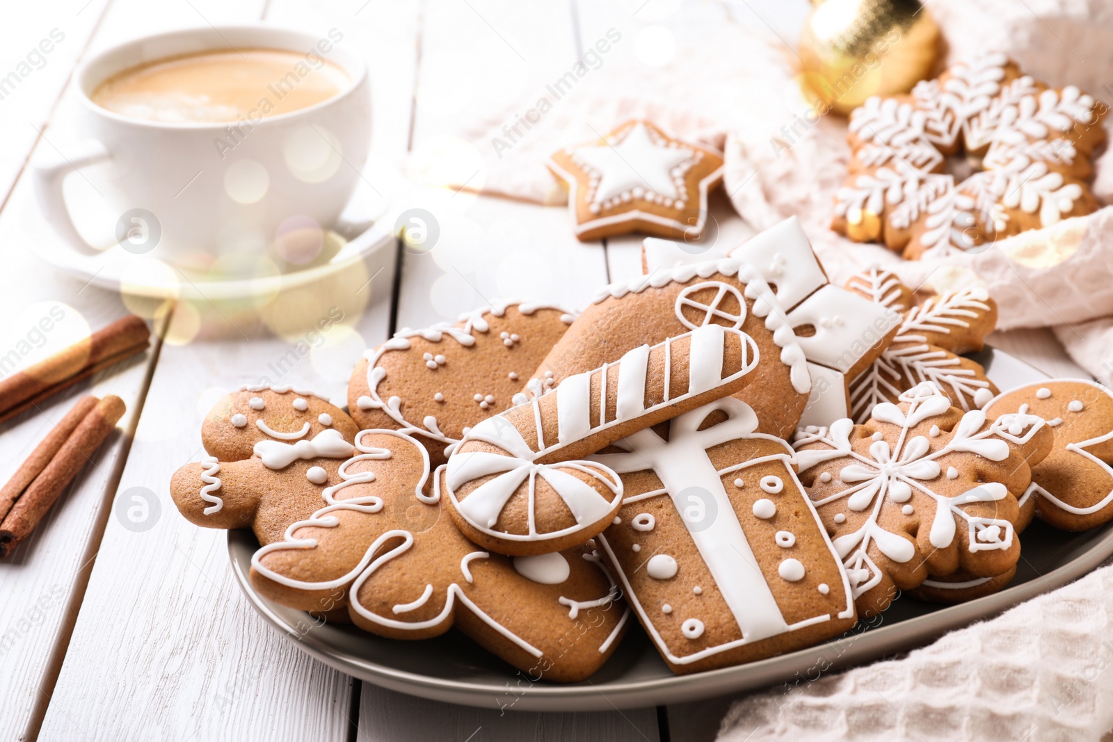 Image of Tasty decorated Christmas cookies on white wooden table. Bokeh effect