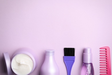 Photo of Flat lay composition with hair cosmetic products on violet background. Space for text