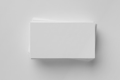 Photo of Blank business cards on white background, top view. Mockup for design