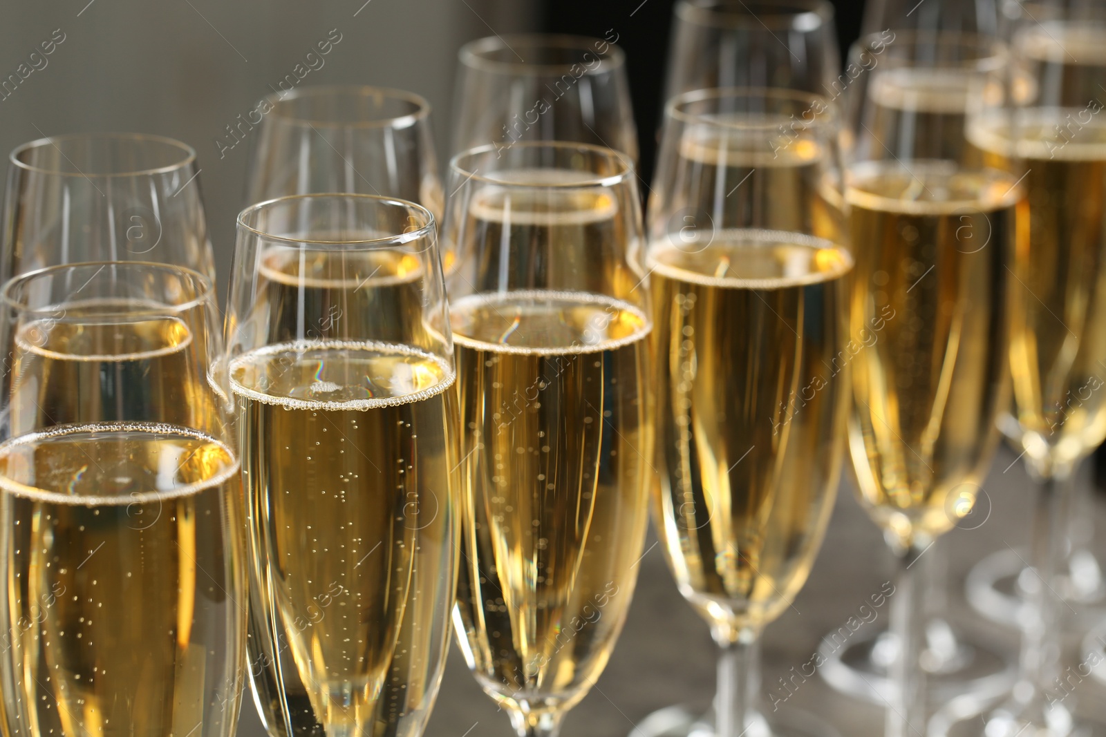 Photo of Many glasses of champagne on table, closeup