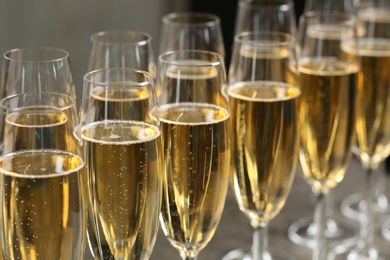 Photo of Many glasses of champagne on table, closeup