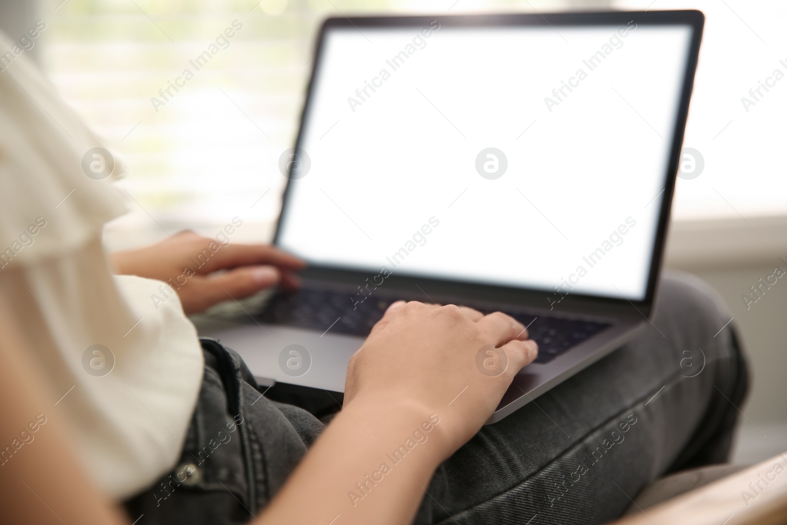 Photo of Woman working with modern laptop indoors, closeup