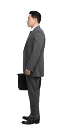 Businessman with briefcase posing on white background