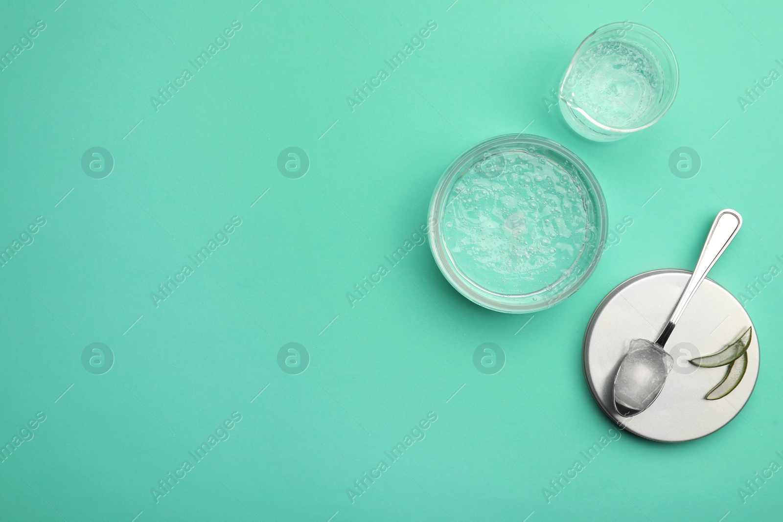 Photo of Flat lay composition with cosmetic gel and aloe on turquoise background, space for text