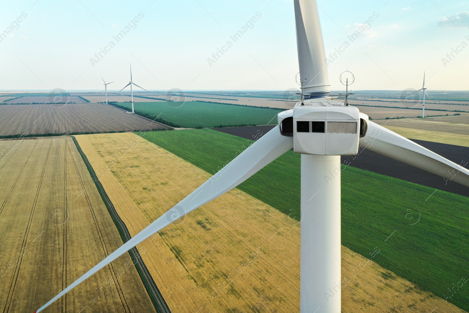 Photo of Modern windmill in wide field, closeup. Energy efficiency