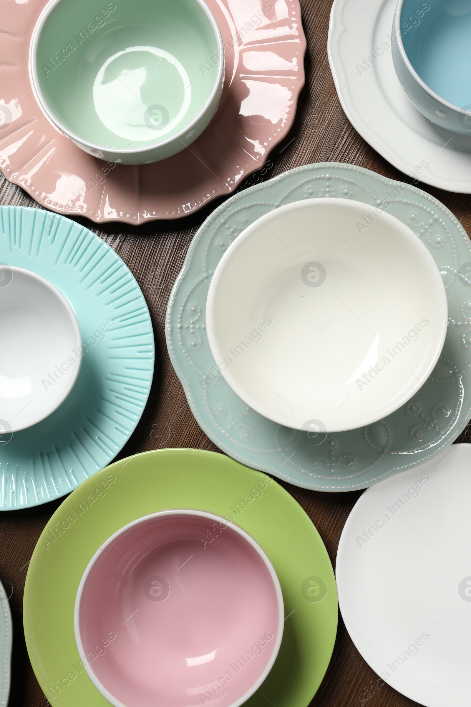 Photo of Beautiful ceramic dishware on wooden table, flat lay