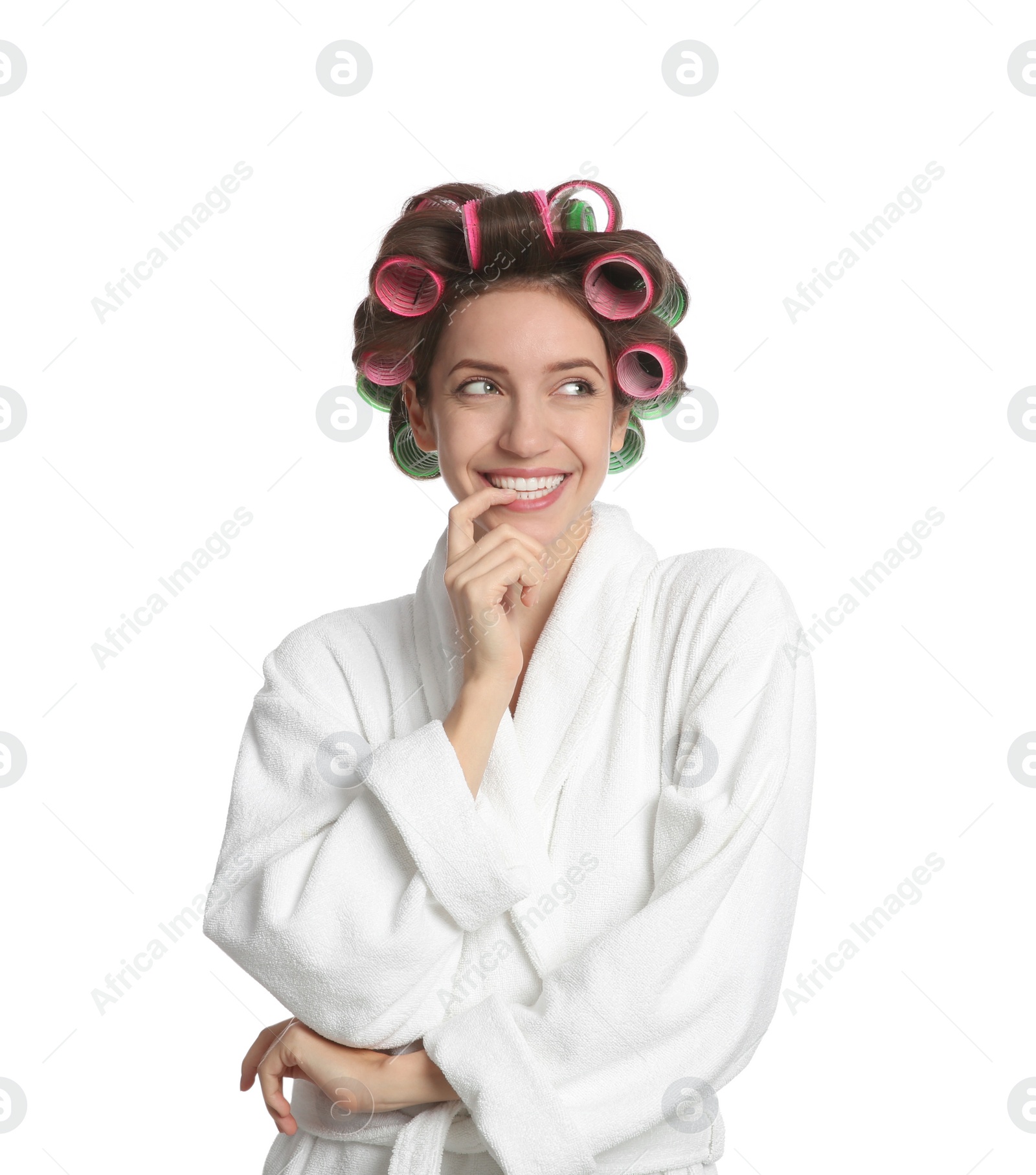 Photo of Beautiful young woman in bathrobe with hair curlers on white background