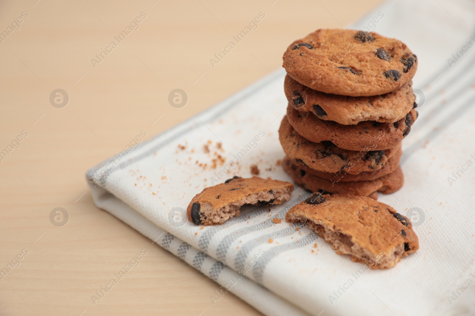 Photo of Tasty homemade cookies with chocolate chips on wooden table