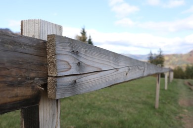 Photo of Closeup view of old wooden fence outdoors