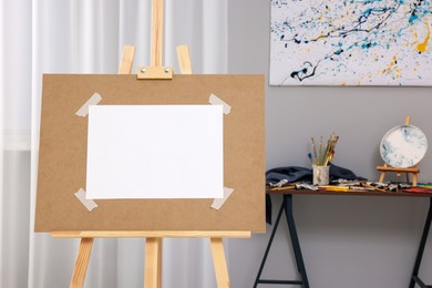 Wooden easel with taped paper in artist's studio