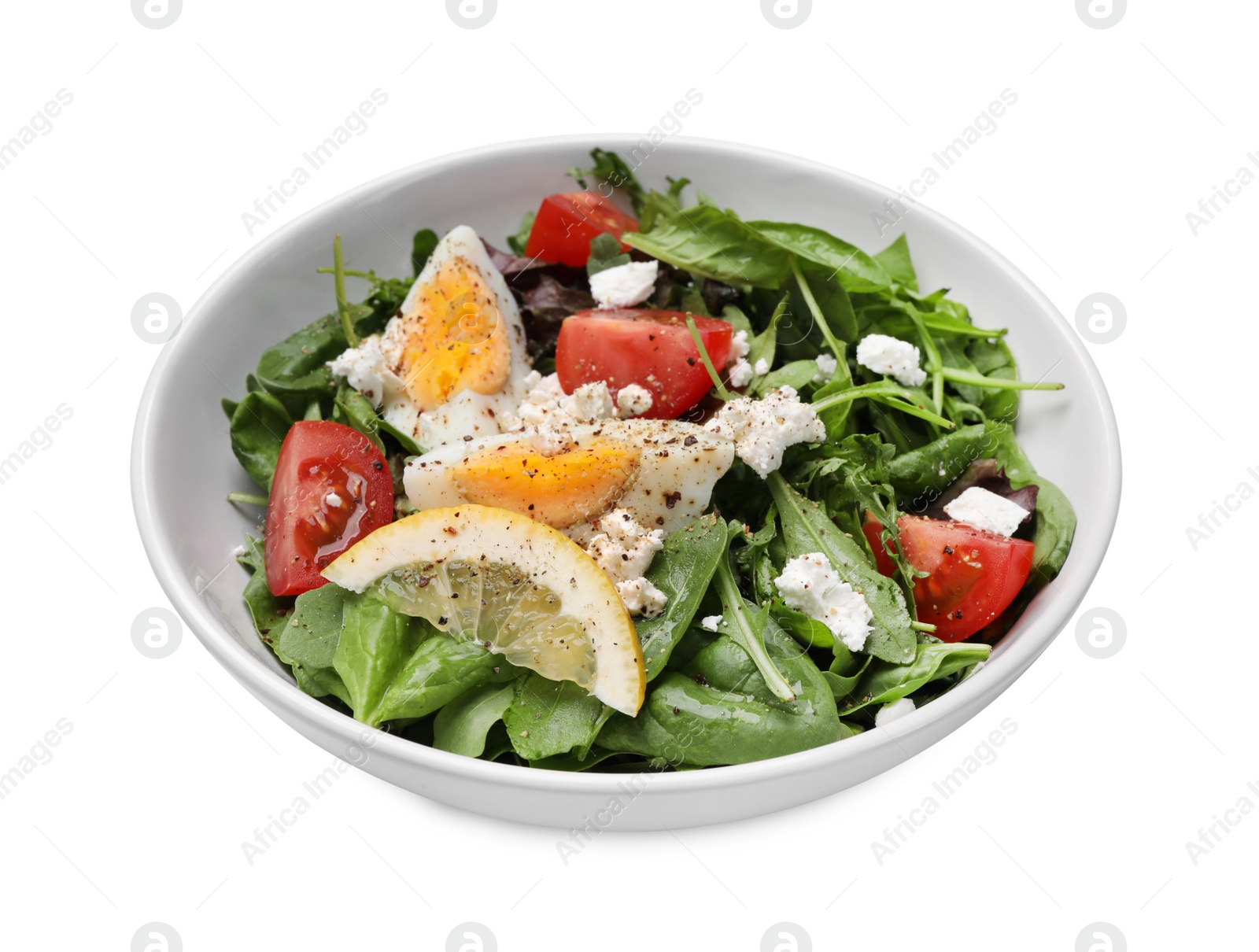 Photo of Delicious salad with boiled egg, tomatoes and cheese in bowl isolated on white