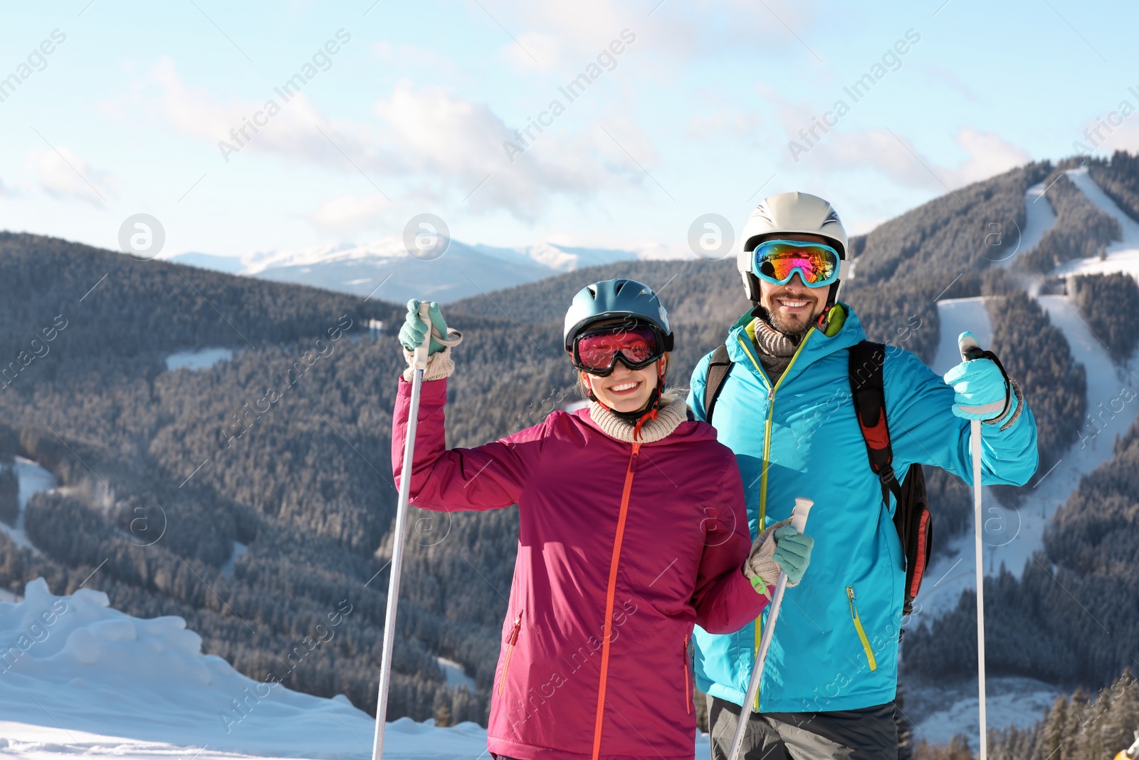 Photo of Couple with ski equipment spending winter vacation in mountains