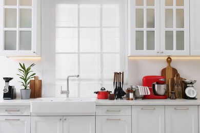 Set of different utensils on countertop in kitchen