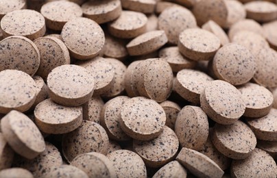 Photo of Brewer`s yeast tablets as background, closeup view