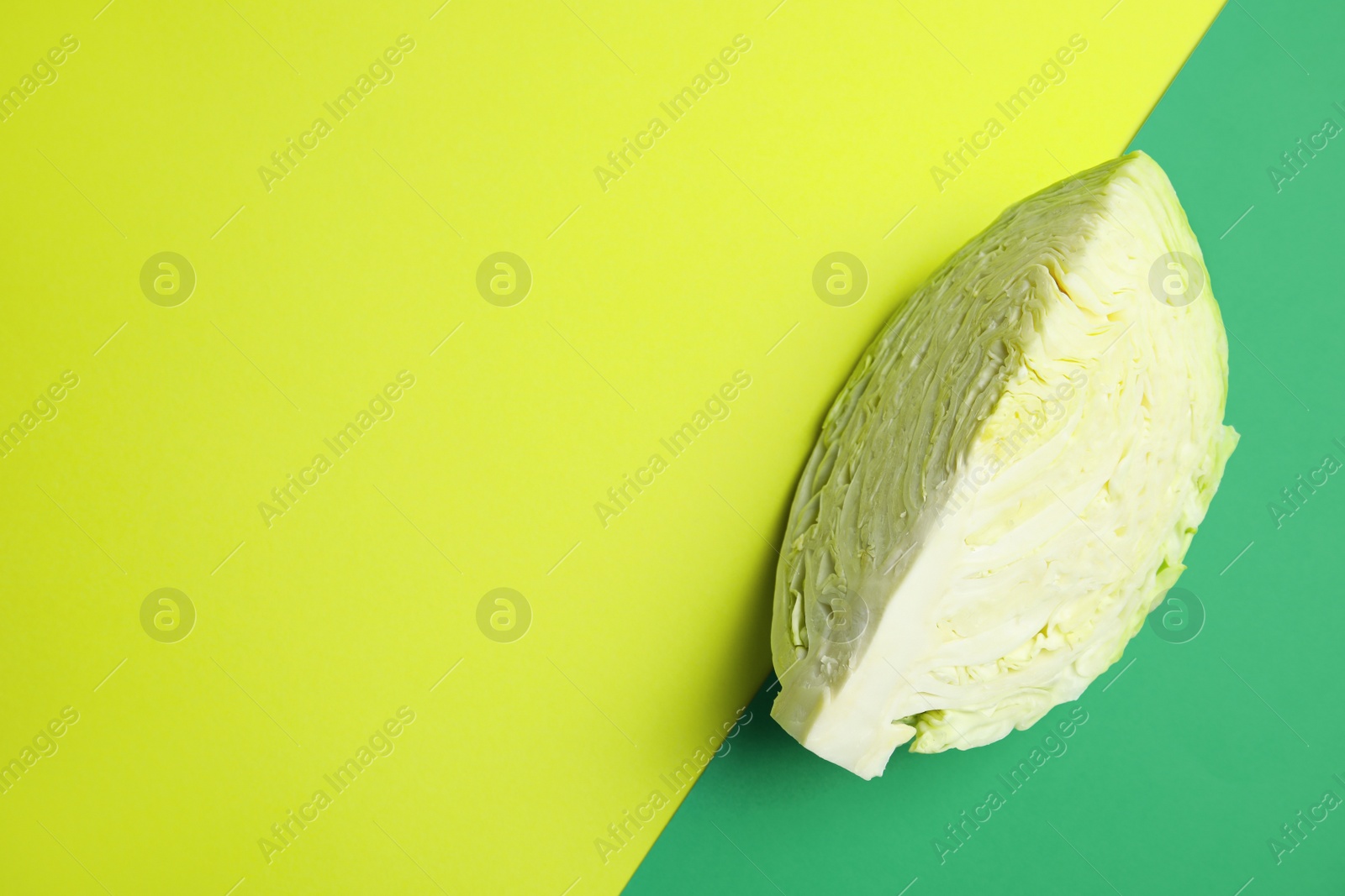 Photo of Cut ripe cabbage on color background, top view