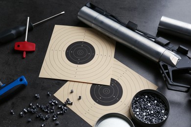 Photo of Composition with sport pistol on black table. Professional gun
