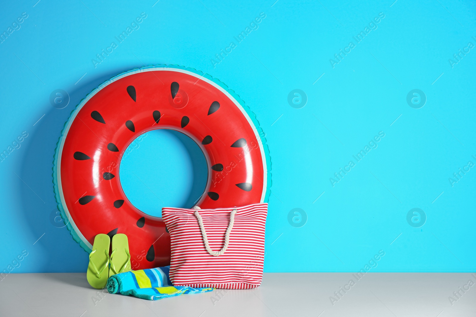 Photo of Beach objects near color wall with space for design. Summer vacation