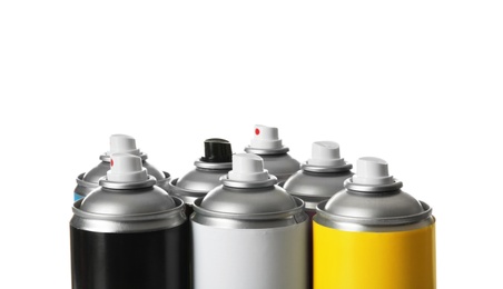 Photo of Cans of different spray paints on white background