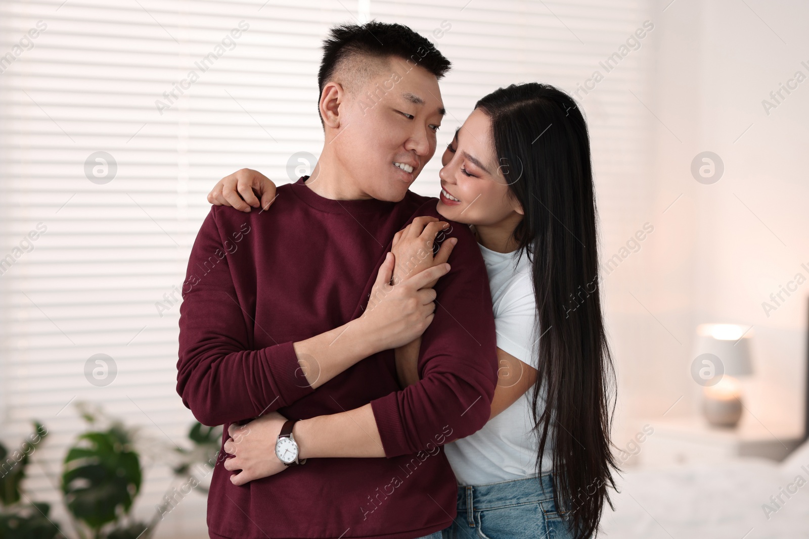 Photo of Portrait of lovely young couple at home