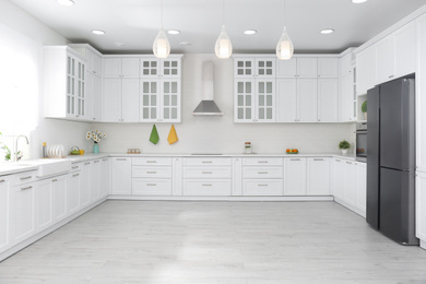 Photo of Modern kitchen interior with stylish white furniture