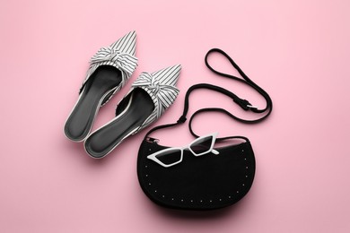 Stylish woman's bag, shoes and sunglasses on pink background, flat lay