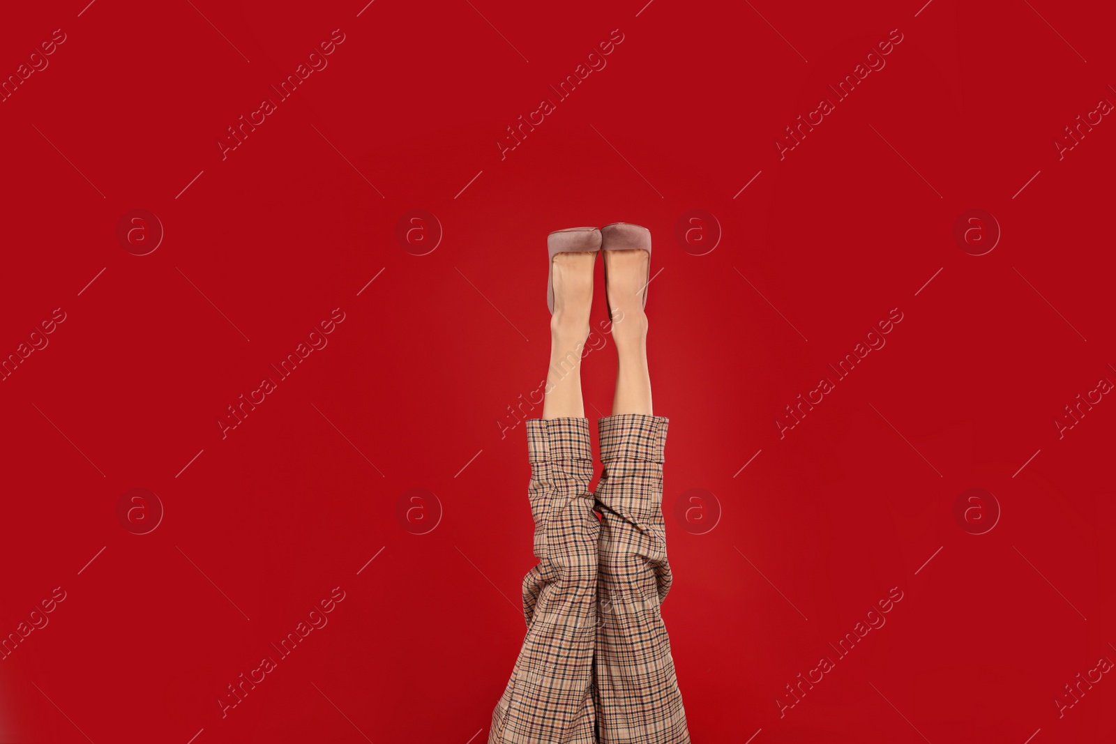 Photo of Woman in elegant shoes on red background