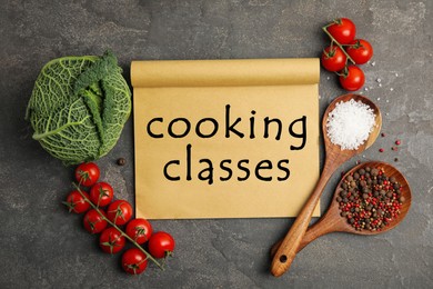 Image of Paper with inscription Cooking Classes and different ingredients on black table, flat lay