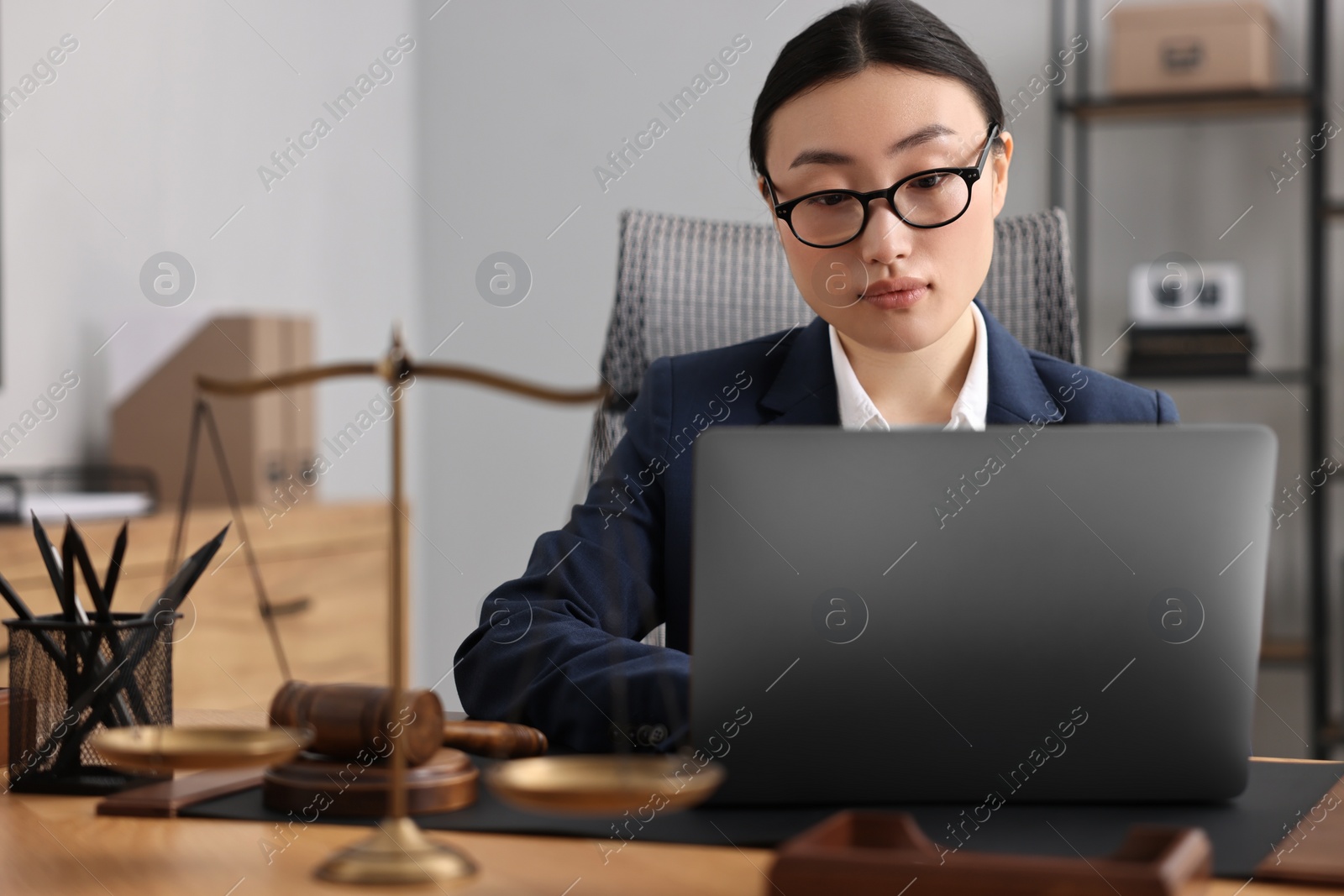 Photo of Notary working with laptop at table in office