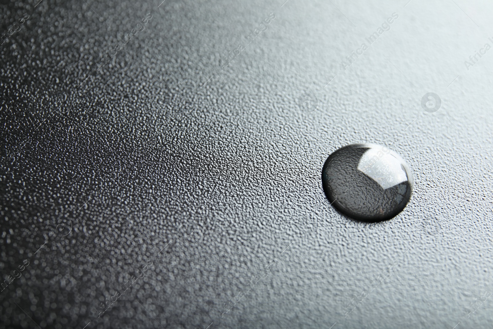 Photo of Beautiful clean water drop on black background