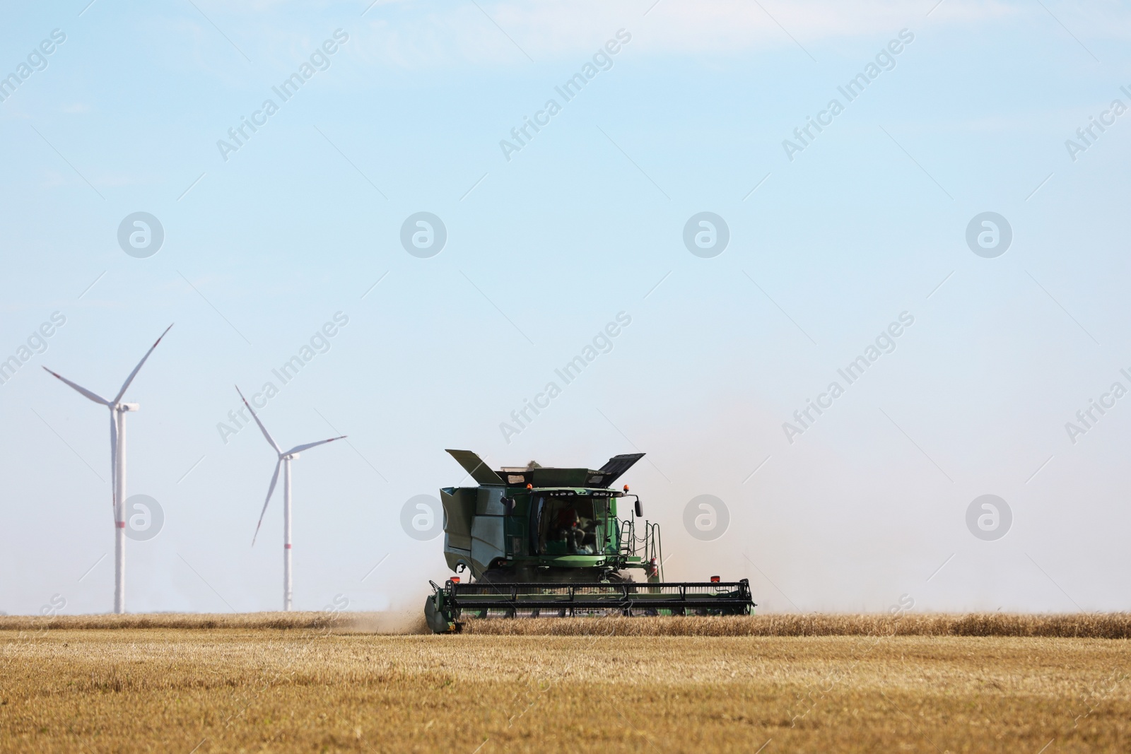 Photo of Modern combine harvester working in agricultural field