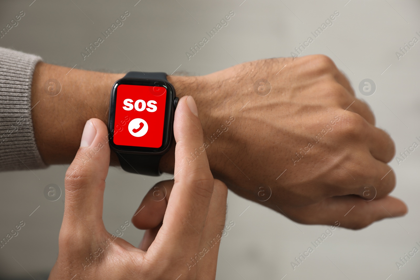 Image of Man using SOS function on smartwatch indoors, closeup