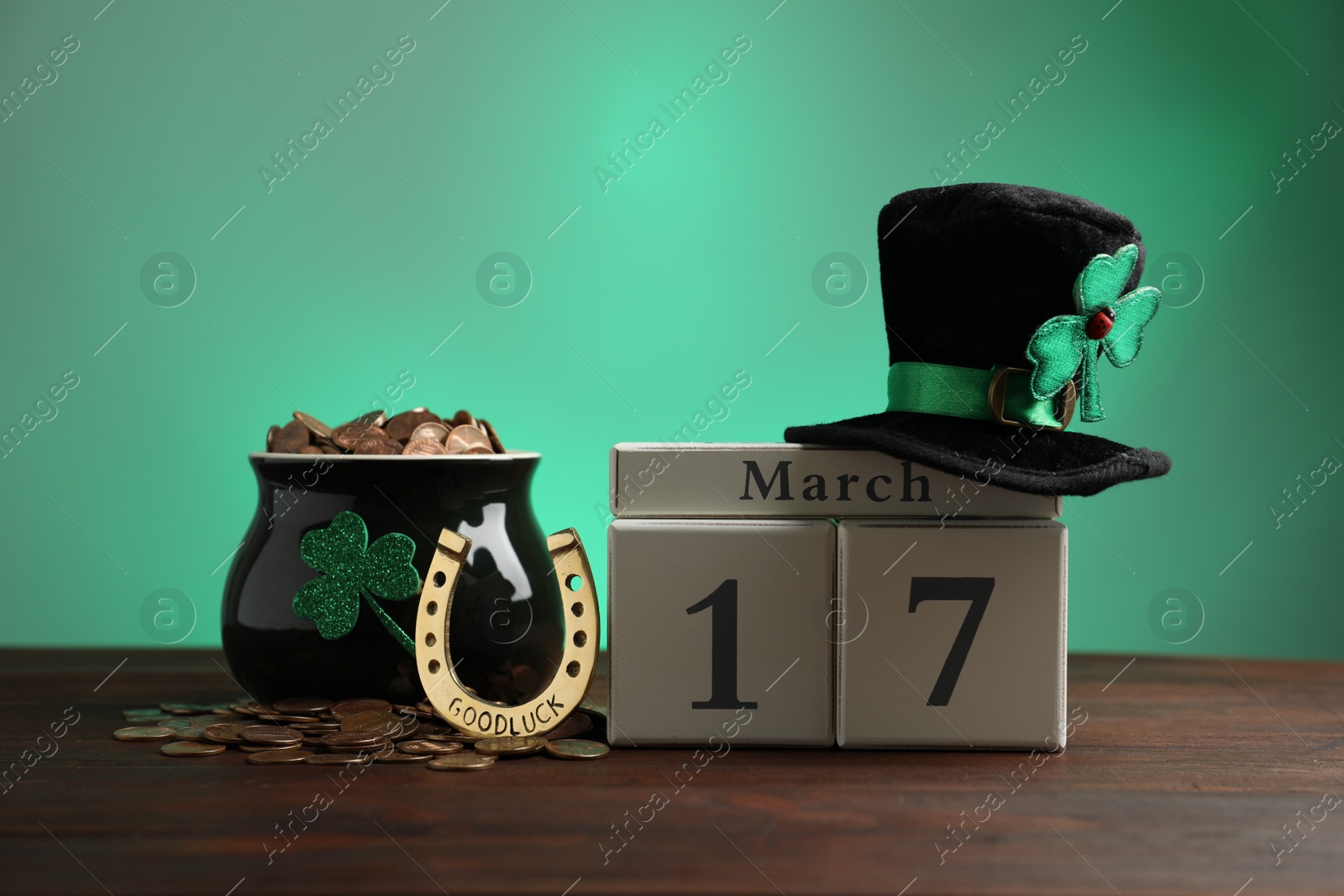 Photo of Composition with block calendar on wooden table. St. Patrick's Day celebration