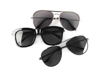 Different stylish sunglasses on white background. Sun protection